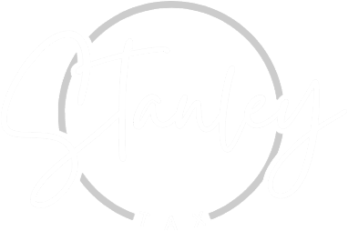 Logo with the word "Stanley" in cursive inside a partial circle, and the word "TAX" in uppercase letters beneath the circle.